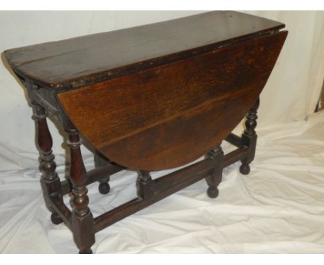 A Charles II oak oval gate leg table with drawer in one end  on baluster supports , 48" x 43"