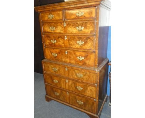 A small George III and later figured walnut chest on chest, the base with three long drawers, the upper portion with two shor