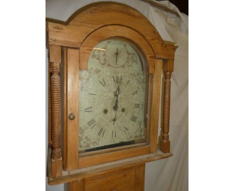 A 19th Century longcase clock with 12" painted arched dial and 8-day movement in polished pine traditional case