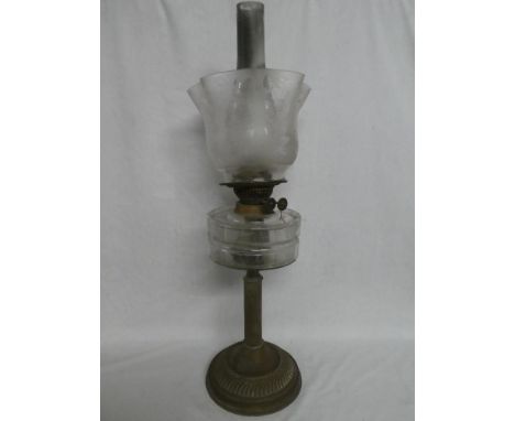 A late Victorian brass oil lamp with fluted column and clear glass reservoir with etched glass shade (shade cracked)