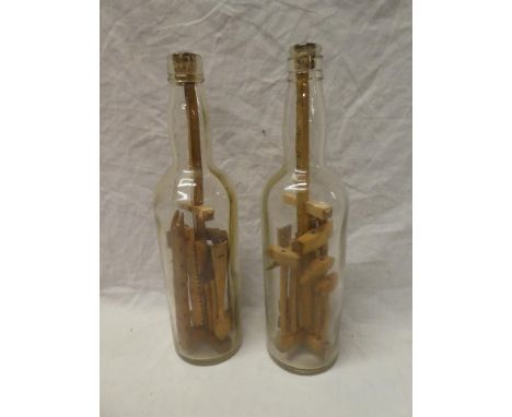 Two glass bottles inset with various wooden mining/carpentry tools dated 1937