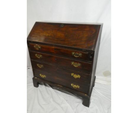 A George III mahogany bureau with pigeon-holes and drawers enclosed by a fall front above four long graduated drawers on brac