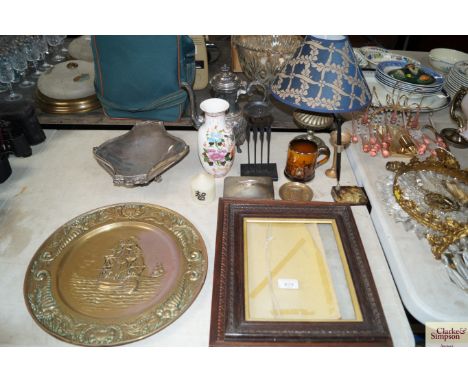 A silver plated swing handled dish, brass embossed plaque, two pho frames, sardine dish, table lamp and shade etc.