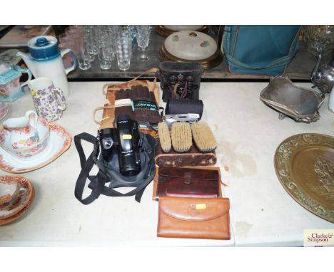 An Olympus camera together with a pair of binoculars with fitted case, leather gloves, brush set etc.