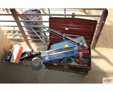 A tin box of tools, drill stand and a tray of tools