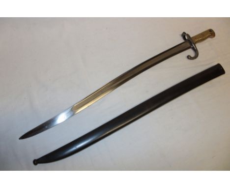 A 19th century French Chassepot bayonet with single edged curved blade marked for St Etienne, brass mounted hilt in steel sca