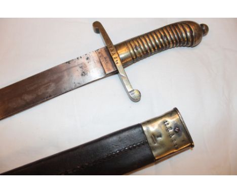 A 19th century German Pioneer's side arm with 19" broad single edged blade, the brass hilt marked "12 R.A.2 25" in brass moun