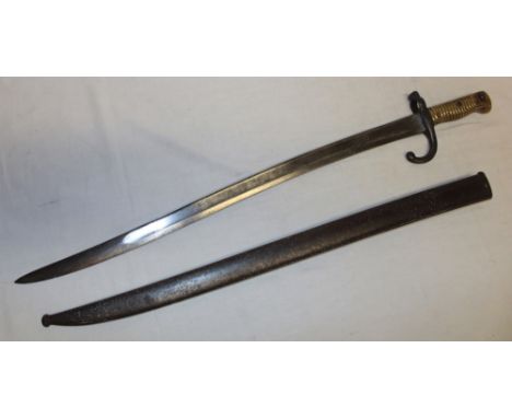 A 19th century French Chassepot bayonet with single edged blade marked for St Etienne 1867, the steel guard with Regimental m