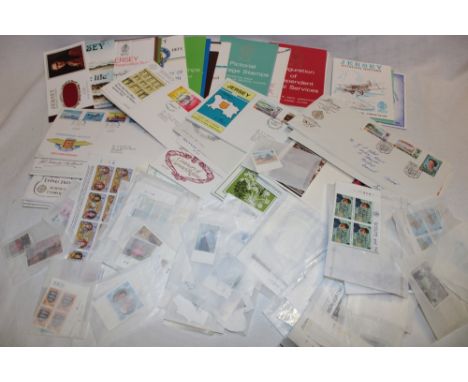 Eighteen Jersey mint stamp presentation packs, a selection of Jersey mint blocks and stamps and a selection of Jersey first d
