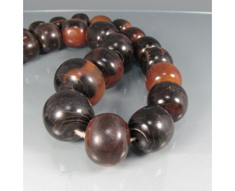 A necklace of African polished horn beads, possibly rhino?
Beads approximately 17 to 38 mm in diameter, length 95 cm, weight 