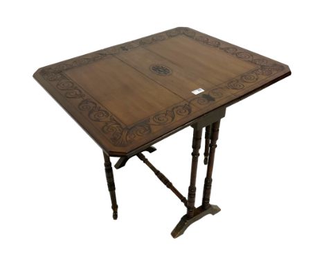 Small late 19th century walnut Pembroke table, the rectangular drop leaf top carved with scrolling foliage band and central r