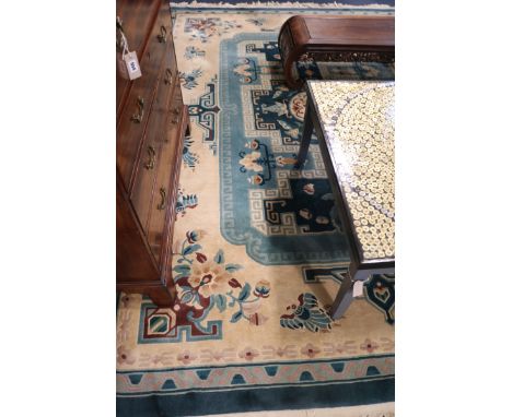 A Chinese blue and cream-ground carpet, 340cm x 244cm