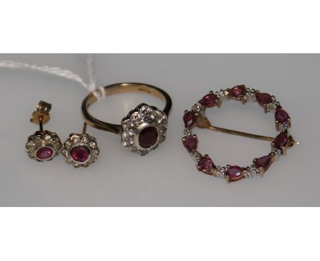 A ruby and diamond 9ct gold cluster ring, a similar target brooch and a pair of earrings.