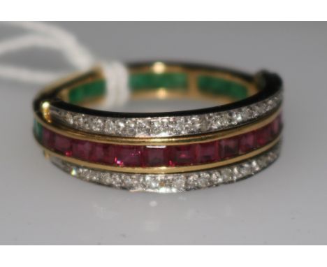 An 18ct gold, ruby, diamond and emerald triple band swivel ring, size R.