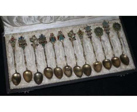 Twelve cased plique a jour enamel coffee spoons.