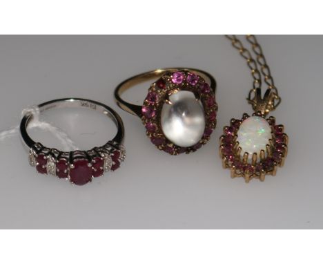 A ruby and diamond 9ct gold half-hoop ring, an opal pendant on chain and a moonstone and ruby dress ring (a.f.)