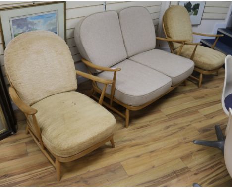 An Ercol light elm two seater and armchairs, all with cushion seats and backs (3), sofa 135cm wide