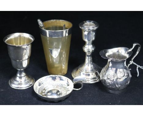 An Edwardian silver cream jug, a silver candlestick, cup, wine taster etc.