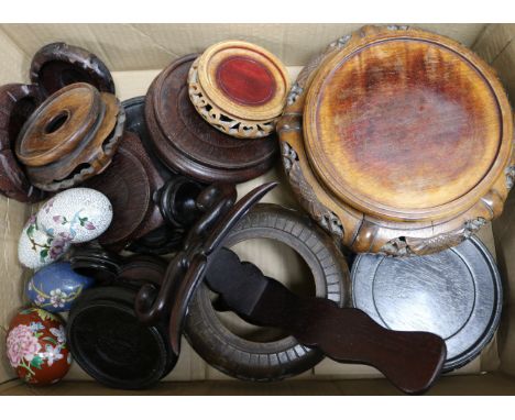 A quantity of wooden Oriental stands and enamel eggs