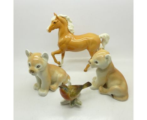 A Beswick Palomino horse, model no.1261 (first edition), two Lomonosov lion cubs and a model bird