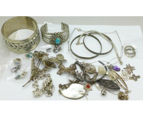 A collection of jewellery including a scarab set bangle and one other wide bangle