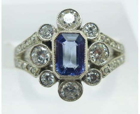 A platinum, sapphire and thirty-five diamond ring, approximately 0.9ct, 5.6g, M½