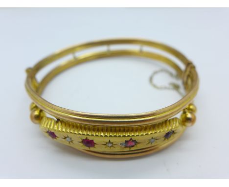 A diamond and red stone set bangle