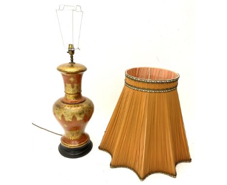 A large table lamp of baluster form, with scrolling gilt decoration upon a red ground, on circular ebonised base, together wi