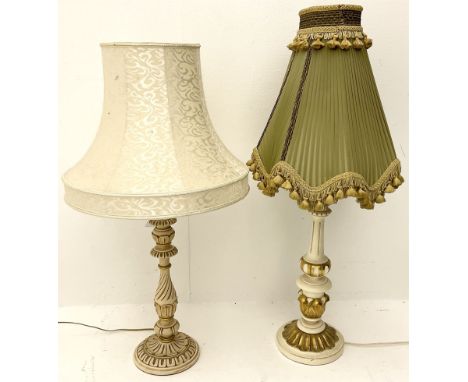 A cream and gilt finished table lamp, the turned base supporting a green pleated and tasselled shade, together with another s