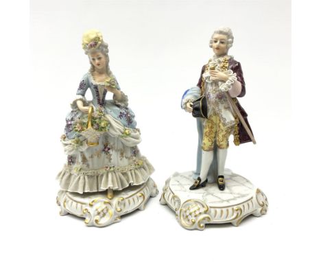 Two Capodimonte figures, the first example modelled as woman with 'lace' skirt holding a basket on a scalloped plinth, the se