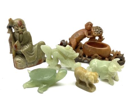 A Chinese carved jade model of a water buffalo, L6cm, together with a tortoise, dragon, and three soapstone models, the first