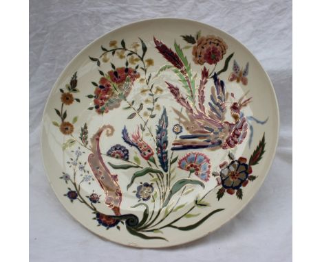 A Zsolnay Pecs pottery charger, decorated with a bird of paradise amongst flowers and leaves, blue printed mark to the base, 