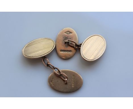 A pair of 9ct yellow gold cufflinks of oval form with line decoration, approximately 8.5 grams