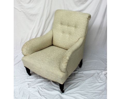 A Victorian upholstered library chair, button back cream upholsterey on bobbin turned front legs on brass casters