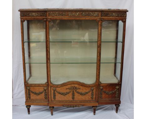 A 19th century French marble topped kingwood, parquetry and ormolu mounted breakfront display cabinet, with a breakfront marb