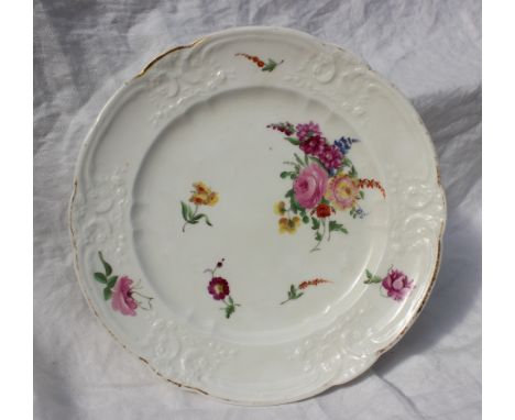 A pair of Nantgarw porcelain plates, with moulded C-scroll borders, both painted with scattered floral sprays and sprigs, gil