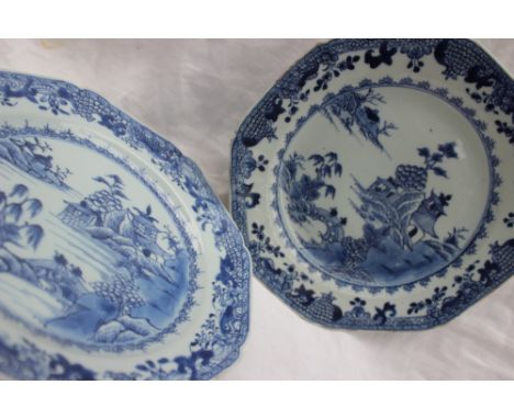 A pair of Chinese blue and white porcelain plates, of octagonal shape, painted with a river scene with figures on a bridge an