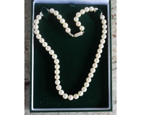 A pearl necklace with fifty four regular pearls to a 9ct yellow gold clasp, approximately 41cm long
