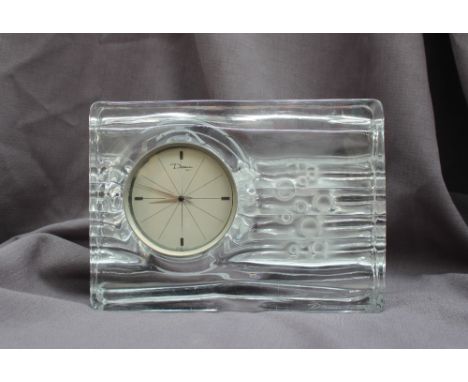 A Daum glass mantel clock the round dial having dauphine hands, with a brushed steel bezel, the rectangular crystal case of w