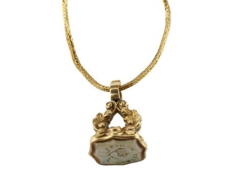 A 19th century hardstone seal fob, intaglio carved with motto "forget me not", in unmarked gold foliate mount on unmarked yel
