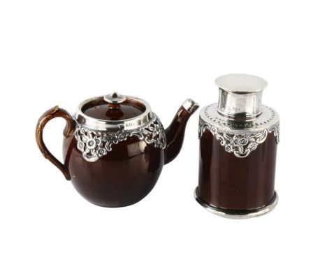 An Edwardian silver-mounted stoneware pottery bachelor's teapot and tea caddy, relief embossed floral decoration, by Henry Bo