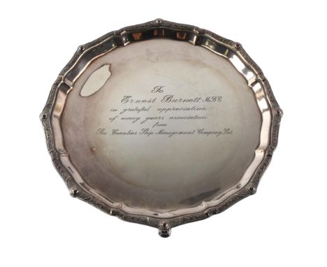 An Elizabeth II silver salver, circular form with Celtic design border and personalised inscription to Ernest Burnett MBE, by