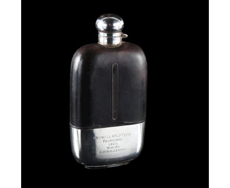 A large Edwardian silver and leather mounted glass spirit flask, with screw-lock cap and detachable silver beaker inscribed "