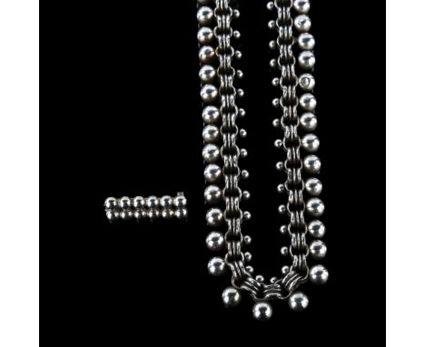 An unmarked silver star and ball fringe necklace, length 40cm, and a miniature ball brooch, 41.7g total (2)No damage or repai