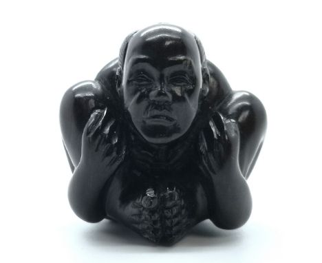 A signed carved Japanese netsuke study of man in yoga position