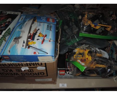 A shelf of mixed vintage Lego including City, Technics and similar, most boxed