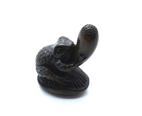 A signed carved wooden Japanese netsuke of a frog seated on a mushroom