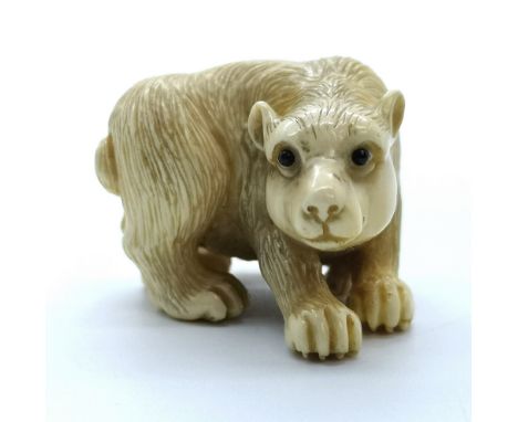 A signed carved ivory Japanese netsuke of a bear