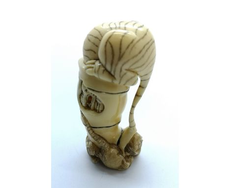 A signed carved ivory Japanese netsuke of a tiger stuck in a bamboo log after chasing three rats who have escaped and are loo