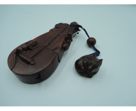 A signed carved fruitwood Japanese Inro in the form of a stringed instrument with carved rats a wooden ojime bead and a carve